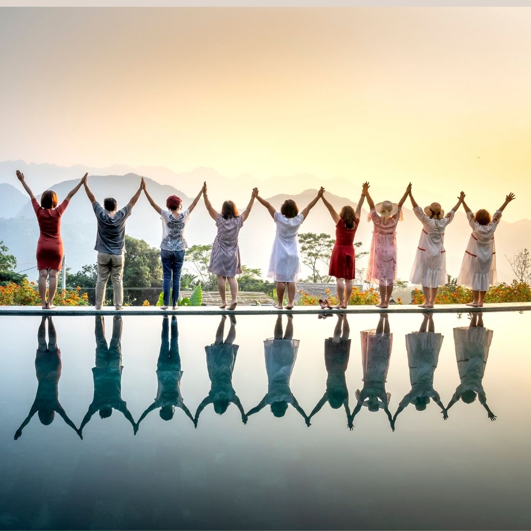 Happy people standing near water