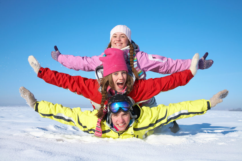 Three smiling people in the cold