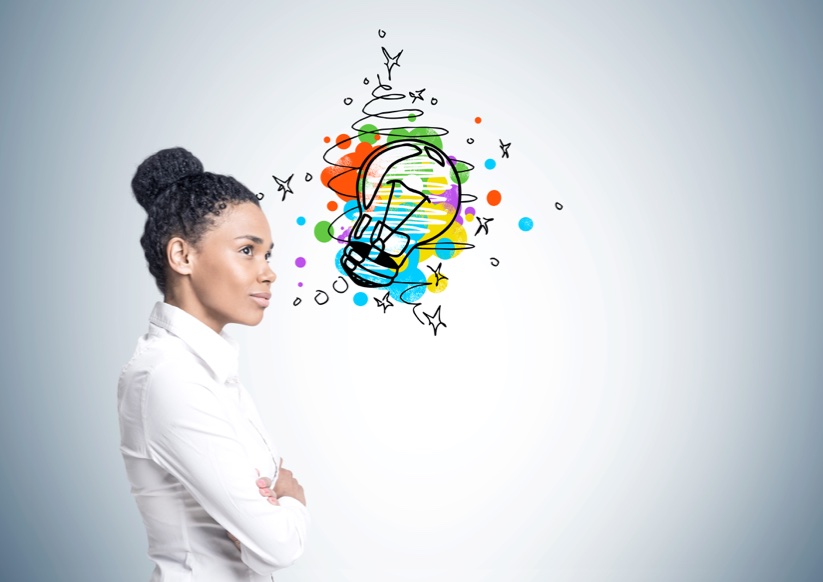 Person standing next to colorful drawing of lightbulb inspiration