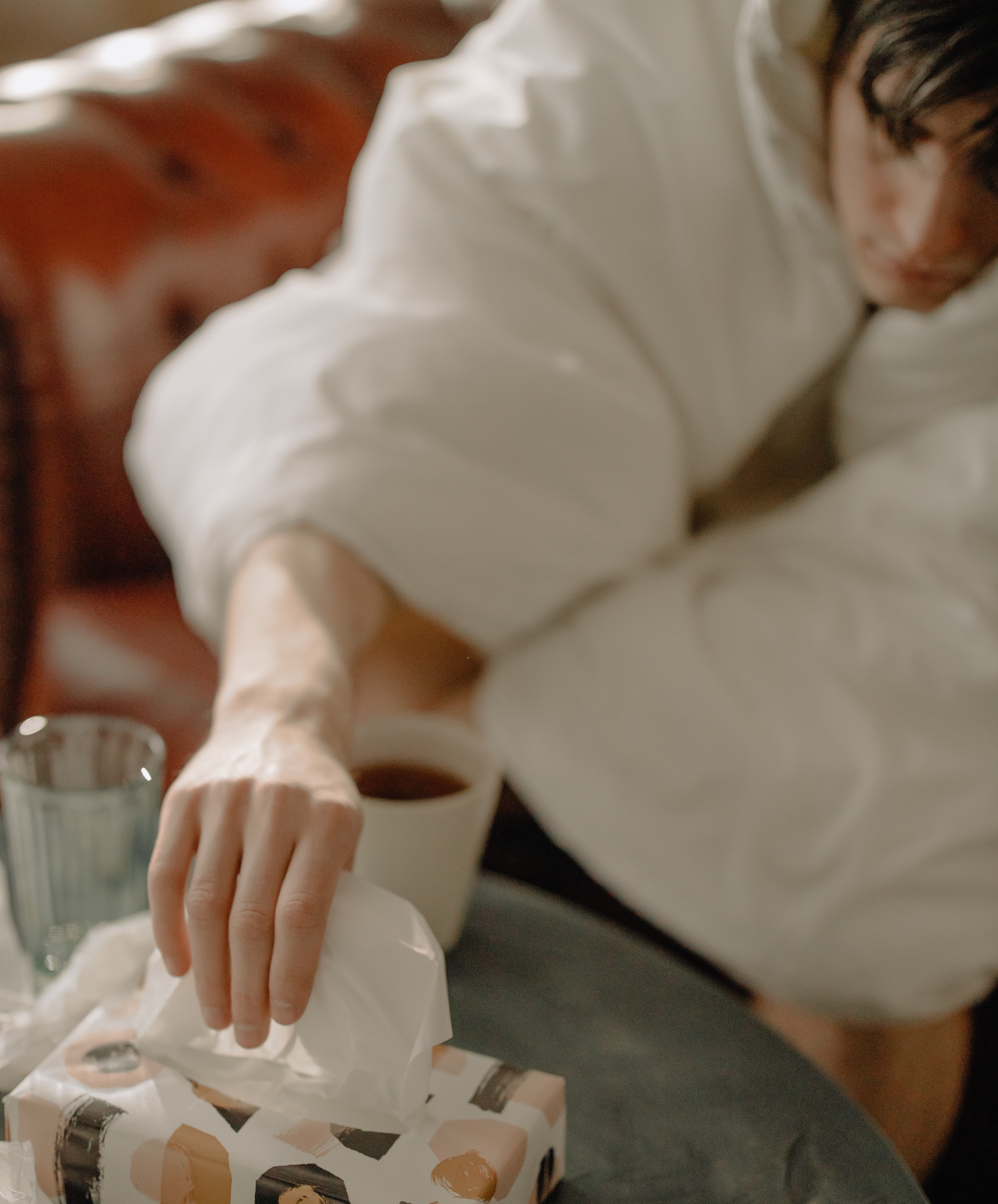 Person reaching for box of facial tissue