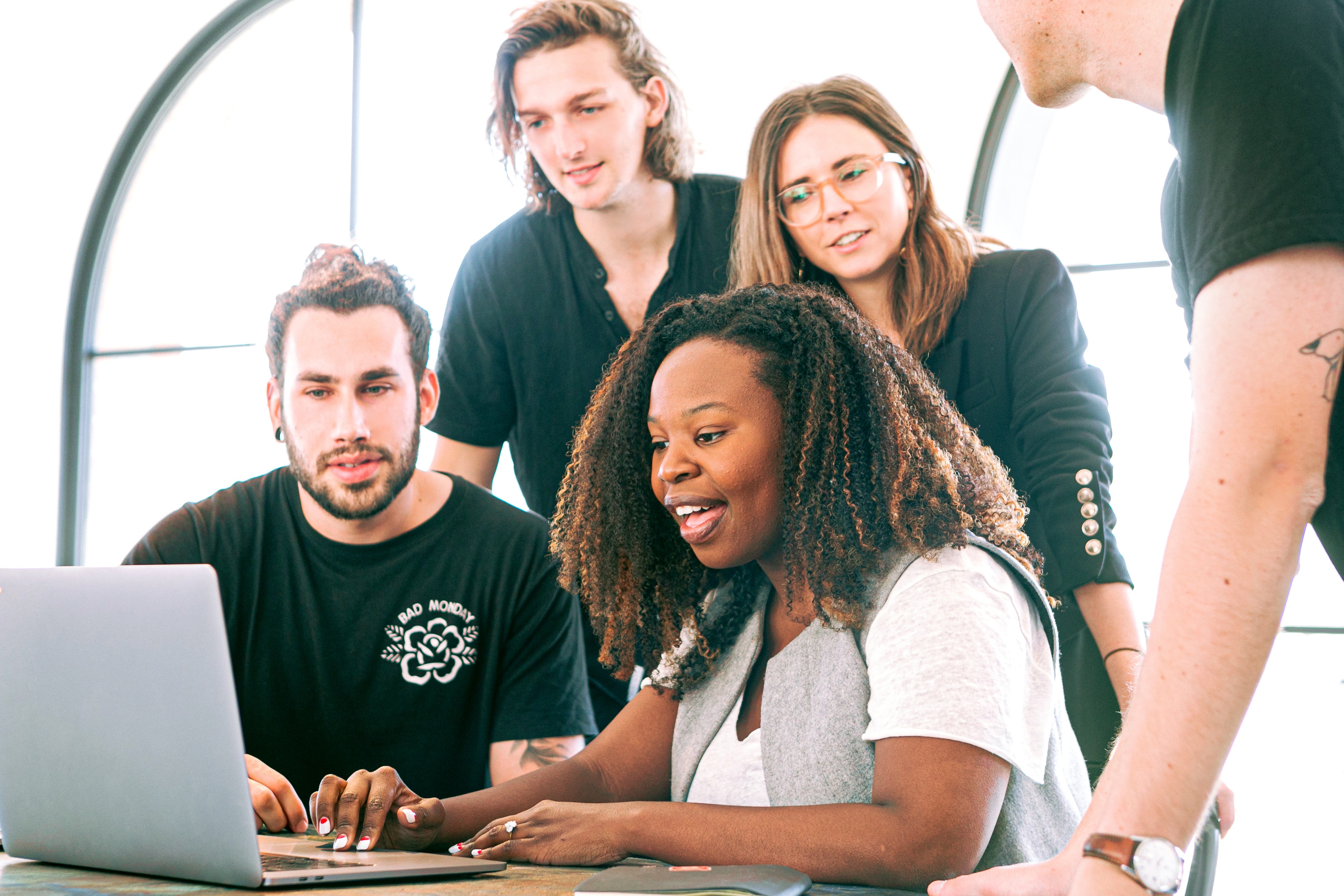 Group of five millennials working